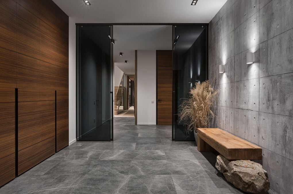 A foyer with marble flooring and a bench