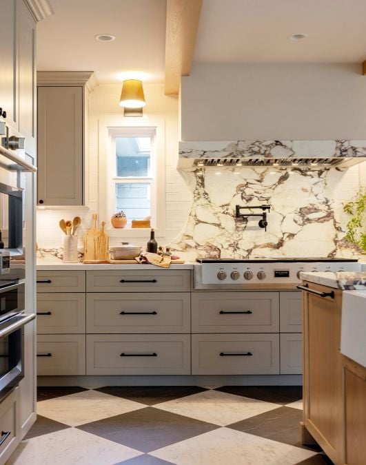 A kitchen with a checkered floor and marble counter tops