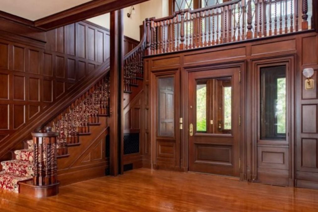 Foyer with a stair case and wooden floors