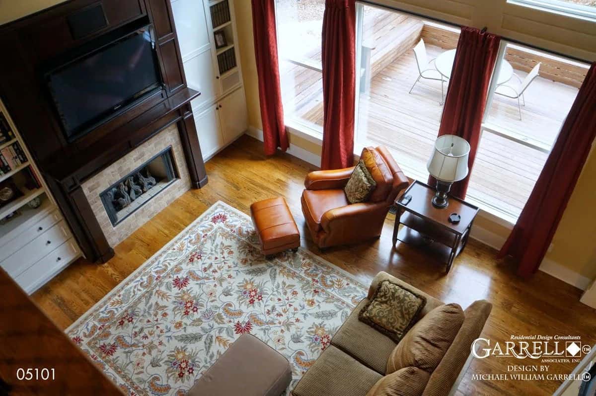 View of the grand room with a fireplace from the balcony.