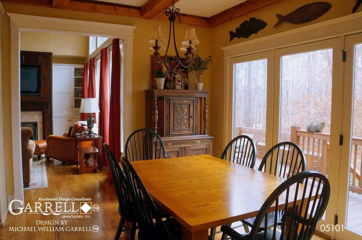 Morning room with round back chairs and a wooden dining table that blends in with the hardwood flooring.