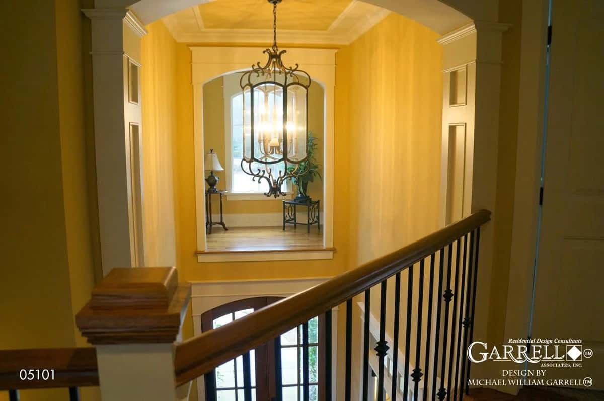 The balcony overlooks the foyer graced with a gallery niche.