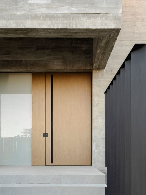 The front entry is adorned with a wooden door.