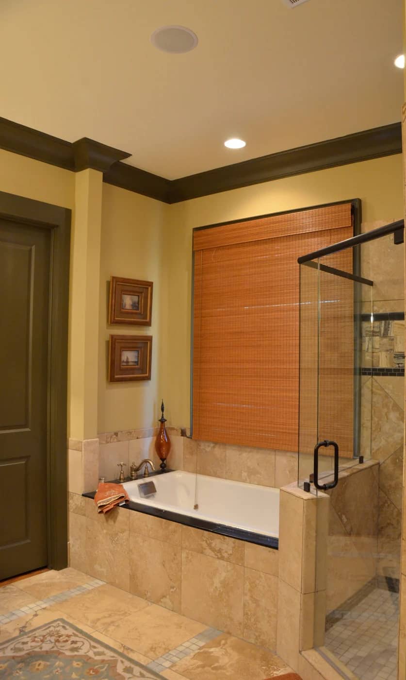 Primary bathroom with a tiled shower and a drop-in bathtub.