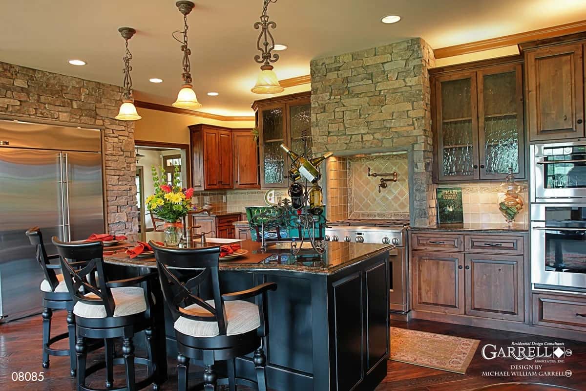 Kitchen with natural wood cabinetry, modern appliances, and a breakfast island with seating for three.