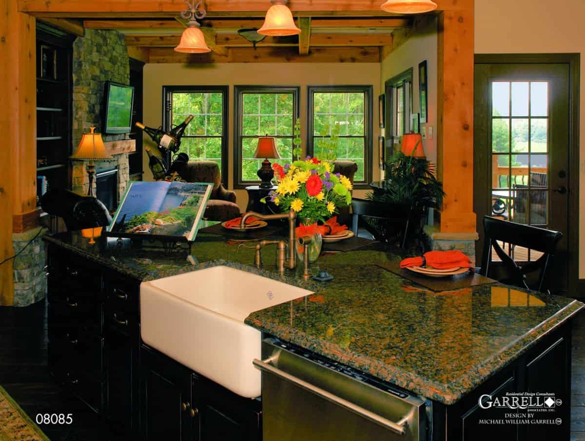 Kitchen island fitted with a farmhouse sink and a dishwasher.