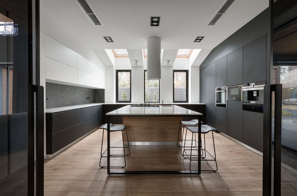 A kitchen with a center island and wooden flooring