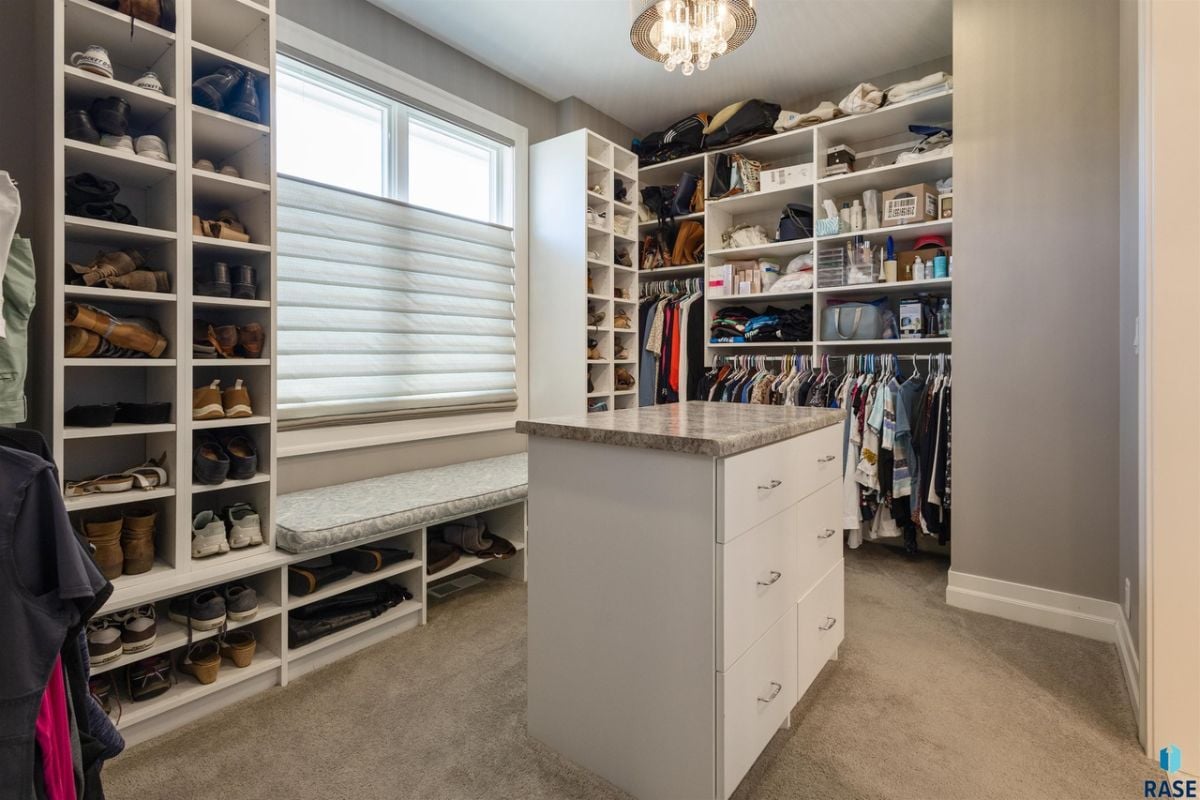 Walk-in closet with shelves and drawers.