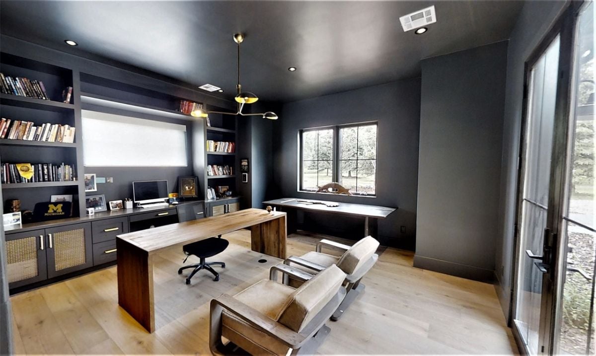 Home office with a desk and shelves.