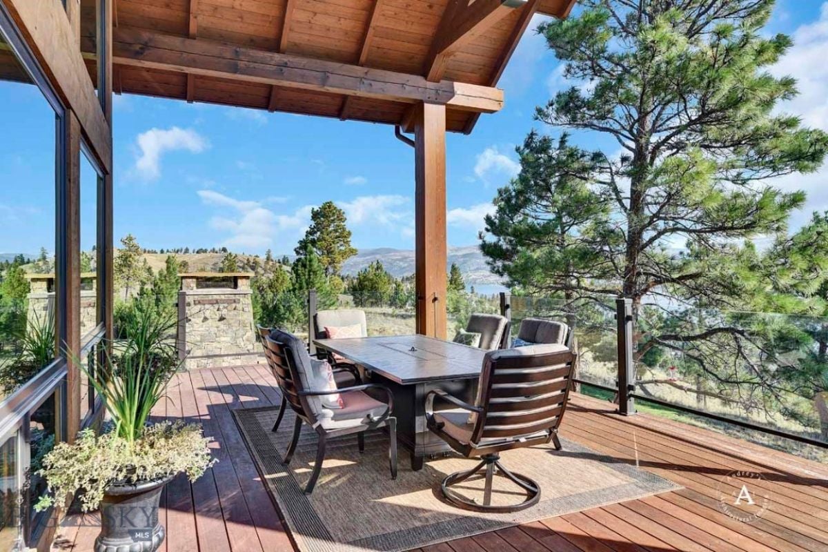Patio with table and chairs with a view of the mountains.
