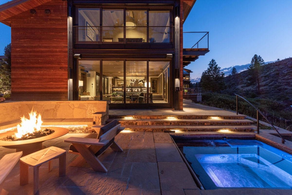 Pool area of the house with a fire it.