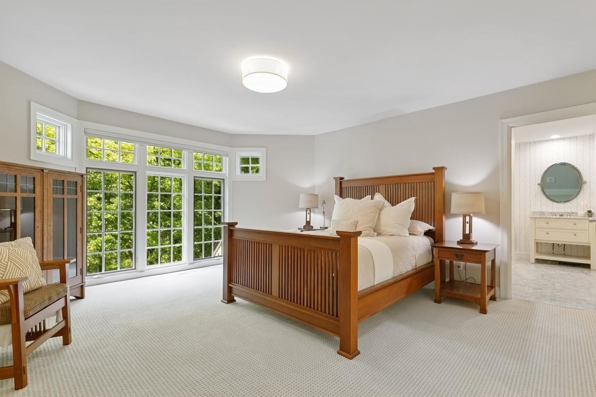 Bedroom with carpet flooring and glass windows.