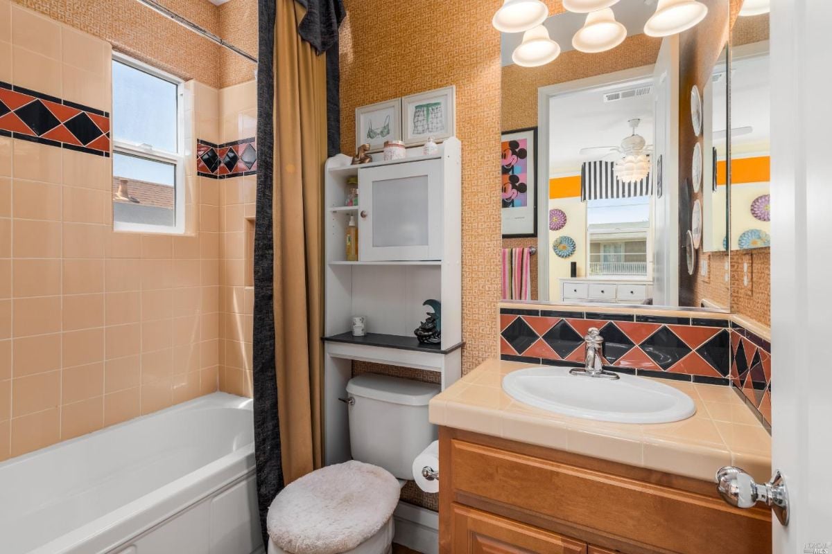 Bathroom with a sink, bath tub and toilet.