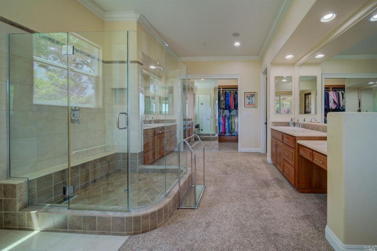 Bathroom with a shower, a sink and large mirrors.