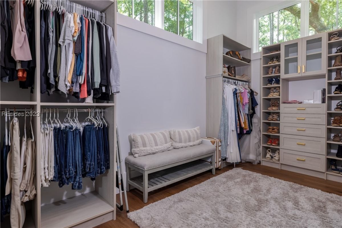 Walk-in closet with shelves, drawers and hangers.