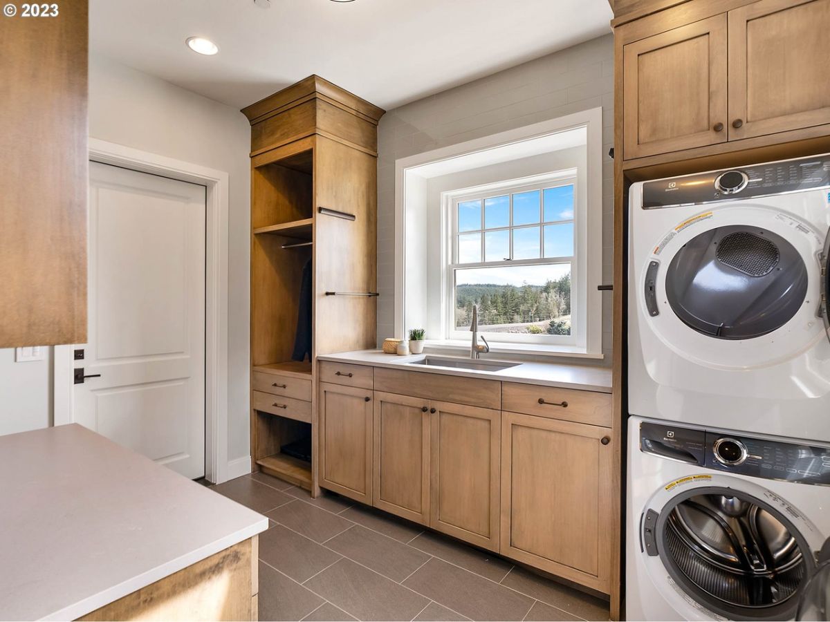 Laundry room with wooden cabinets and drawers.
