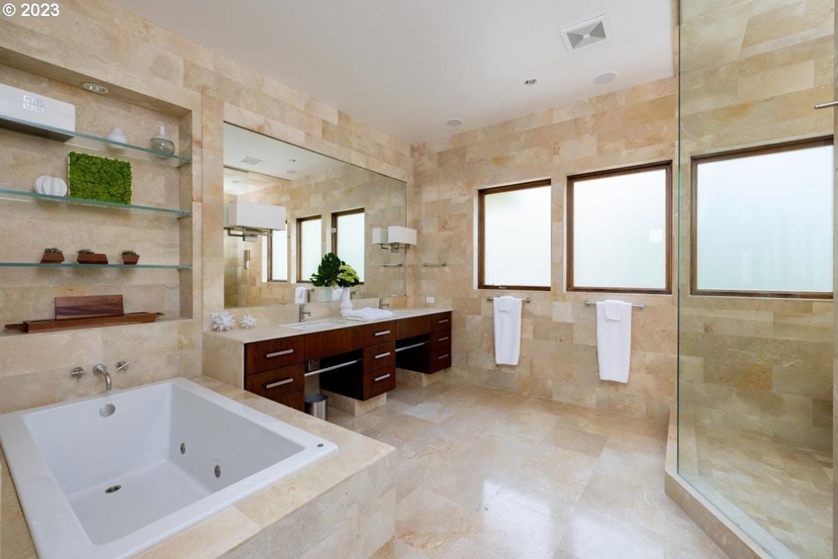 Bathroom with sinks, soaking tub and a shower.