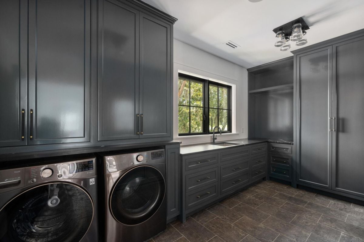 Laundry room with custom millwork pantry cabinets, recessed counter-depth, front-loader washer and dryer.