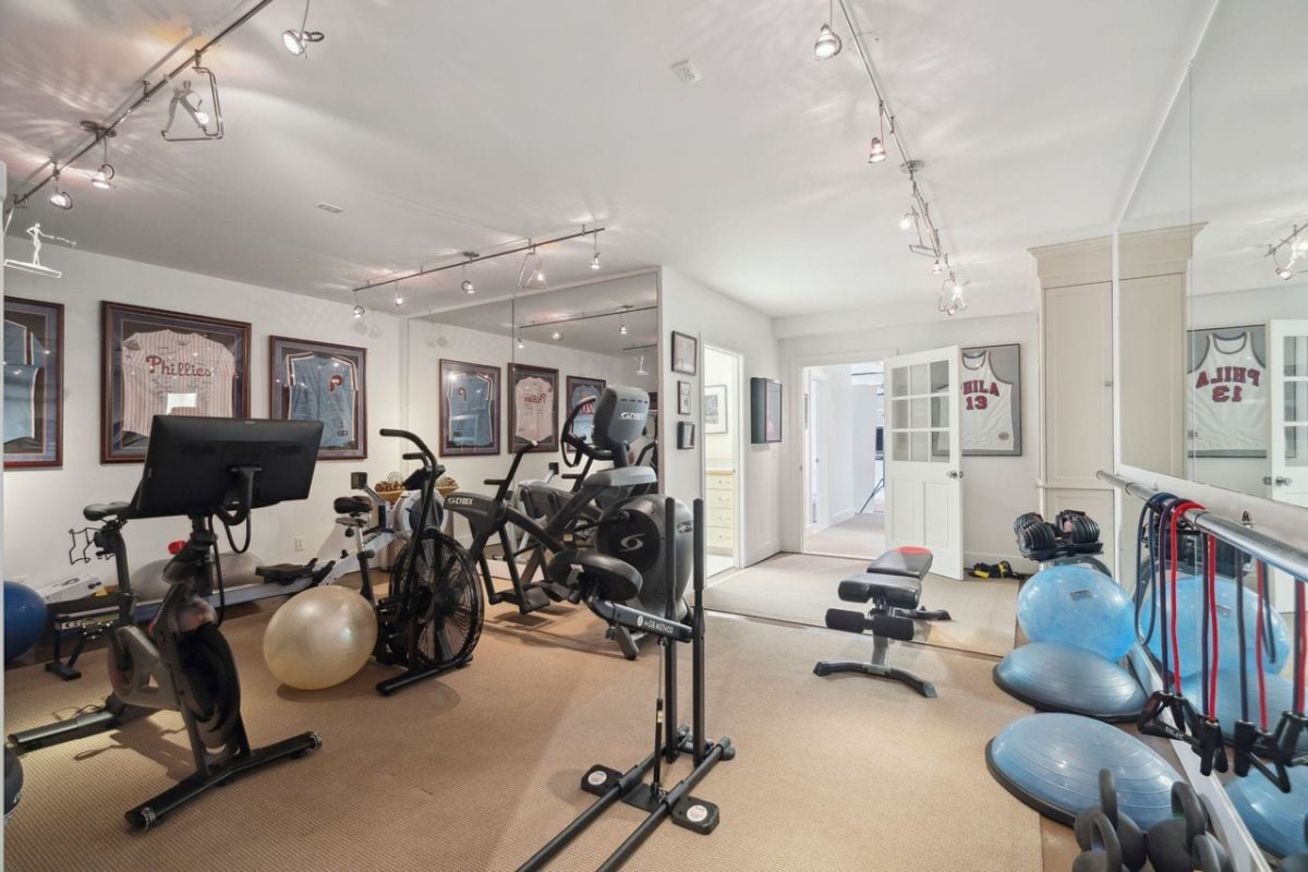 Home gym with carpet flooring, workout equipment, and custom lighting.