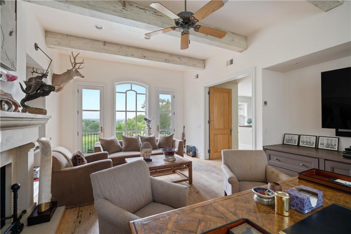 Another living space with brown sofas.