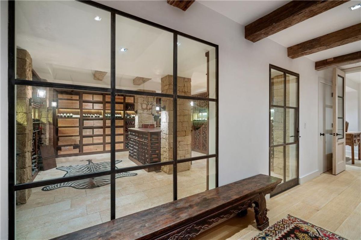A glass wall that leads to the wine cellar.