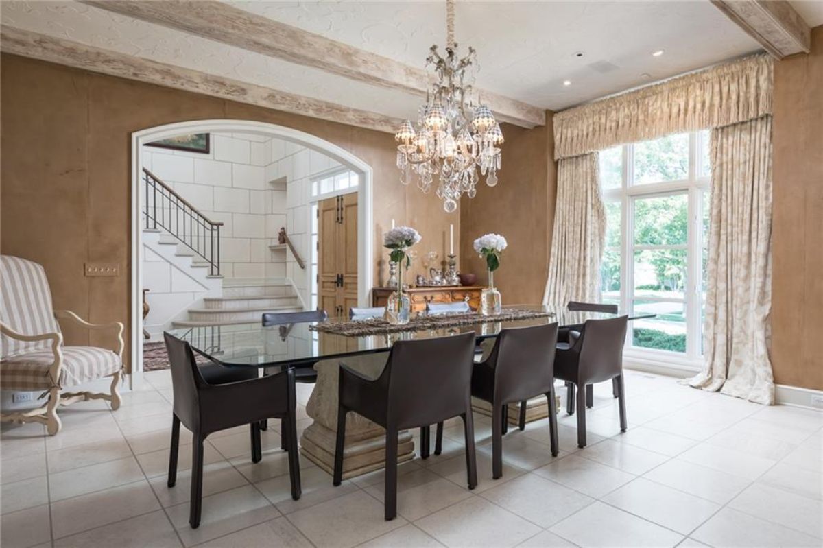 Dining room with black chairs and long table.