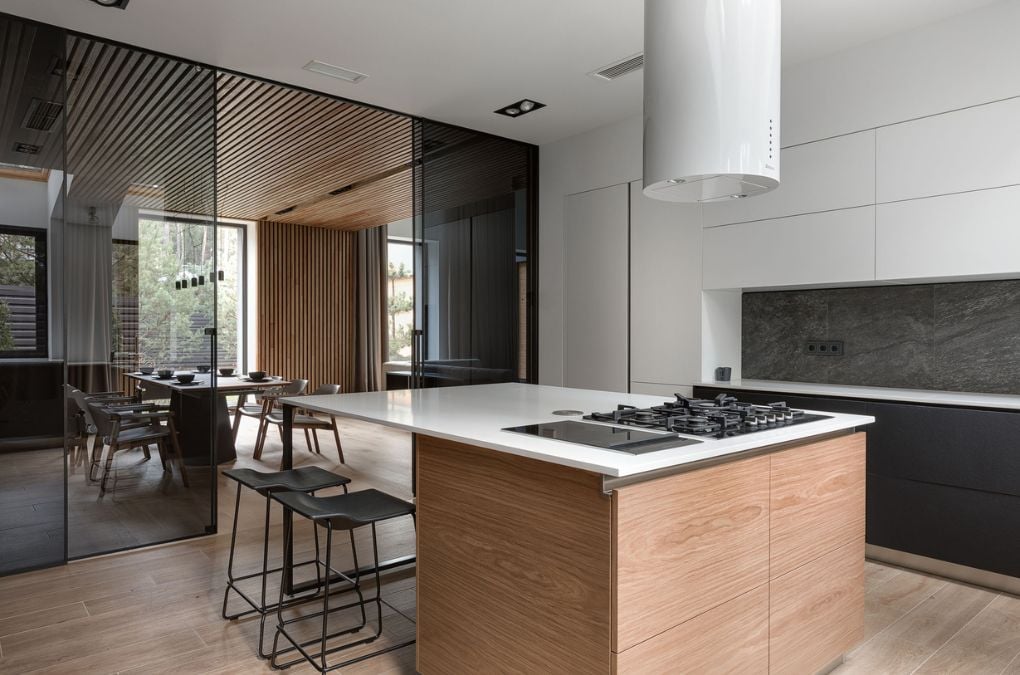 A kitchen with center island and full height sliding glass door