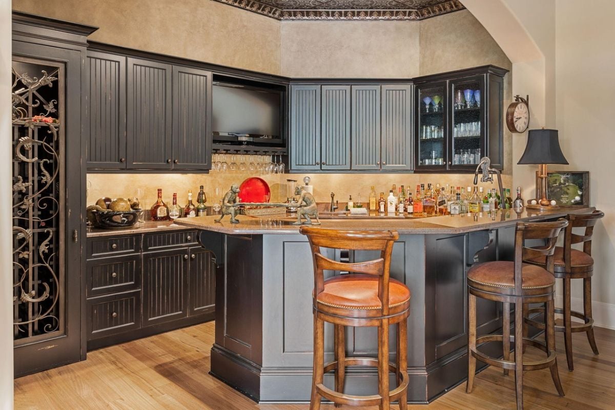 Bar with custom cabinetry and granite countertops.