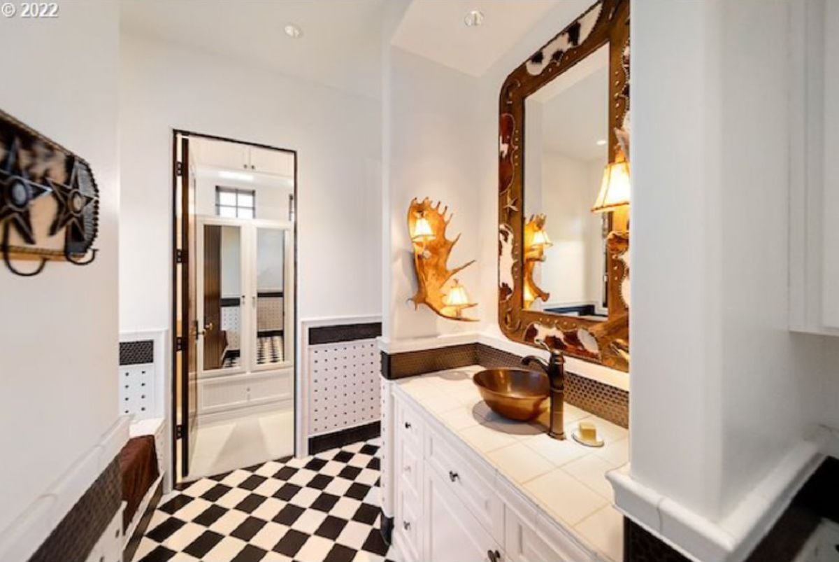 Bathroom with tile flooring, a sink and custom lighting.