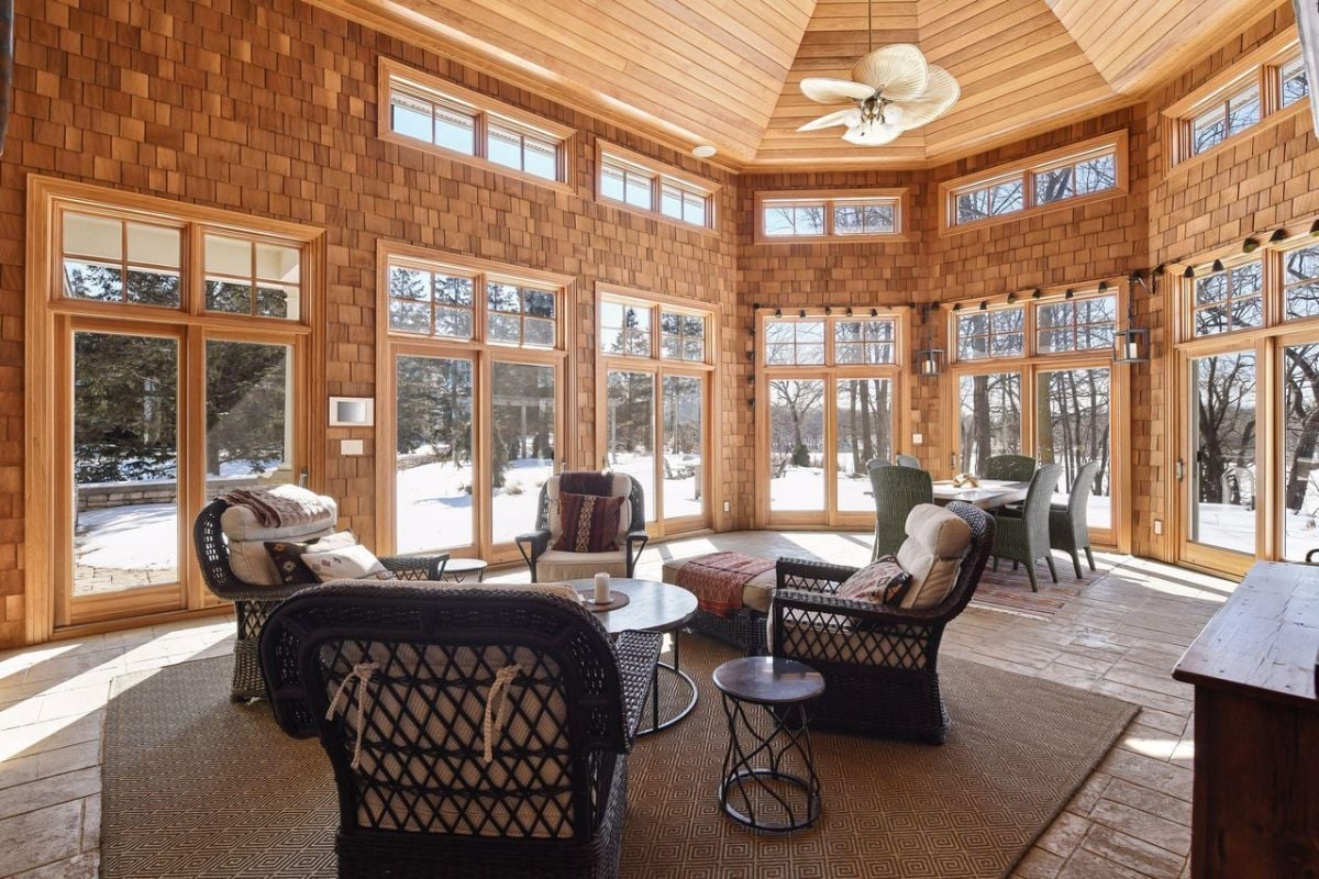 Sun drenched family room with couches and tables.
