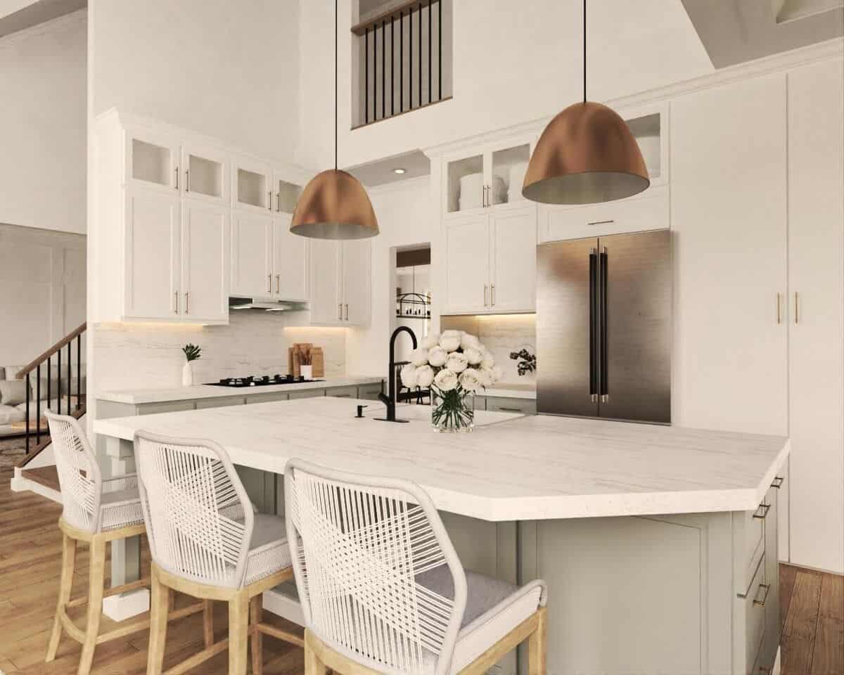 Kitchen with white cabinetry, marble countertops, and breakfast island with three seating.