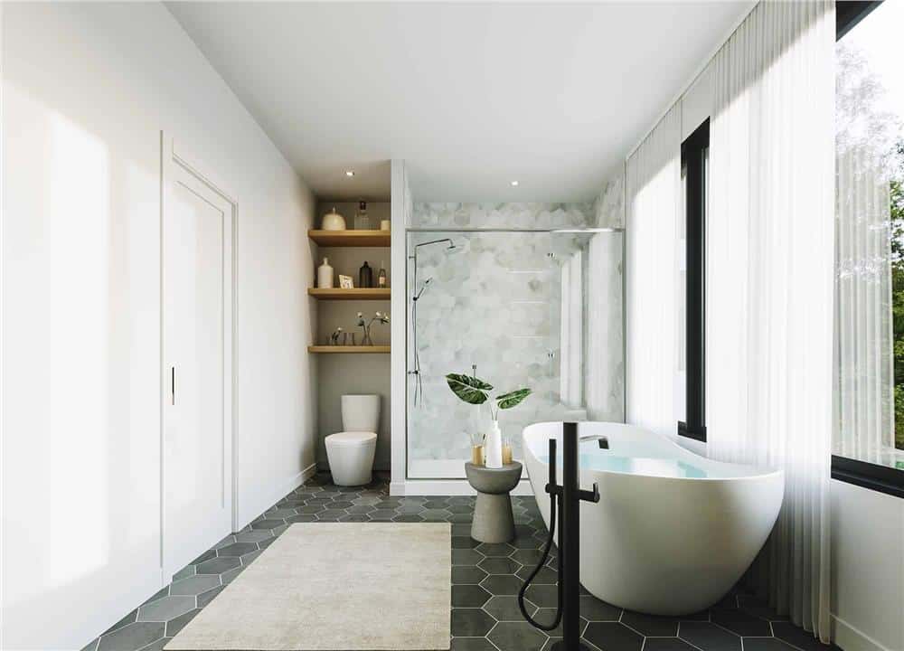 A toilet beside the tiled shower with floating shelves on top completes the primary bathroom.