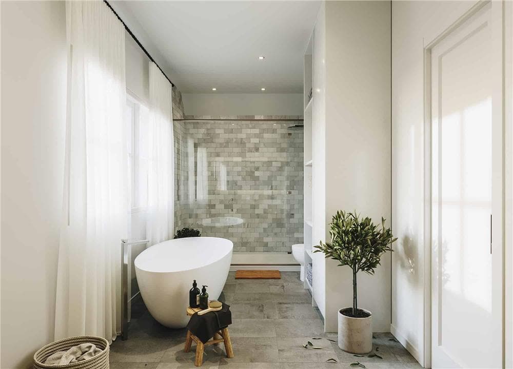 The primary bathroom includes a walk-in shower clad in white and gray marble tiles.
