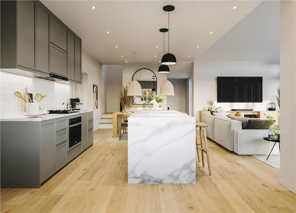 Kitchen with gray cabinets and a waterfall island with bar seating.