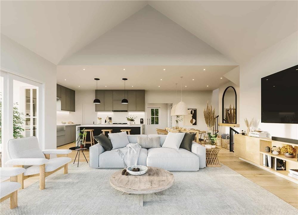 Living room with gray seats, a rustic coffee table, and a large TV mounted above the wooden console table.