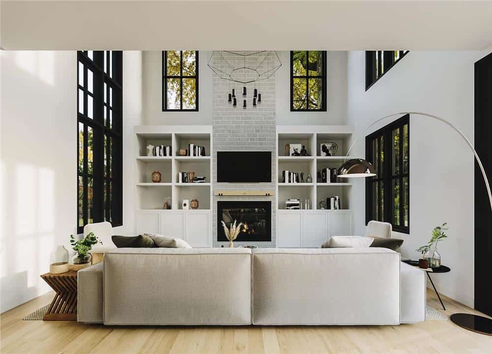 Living room with a modern sofa and a brick fireplace flanked by built-in bookshelves.