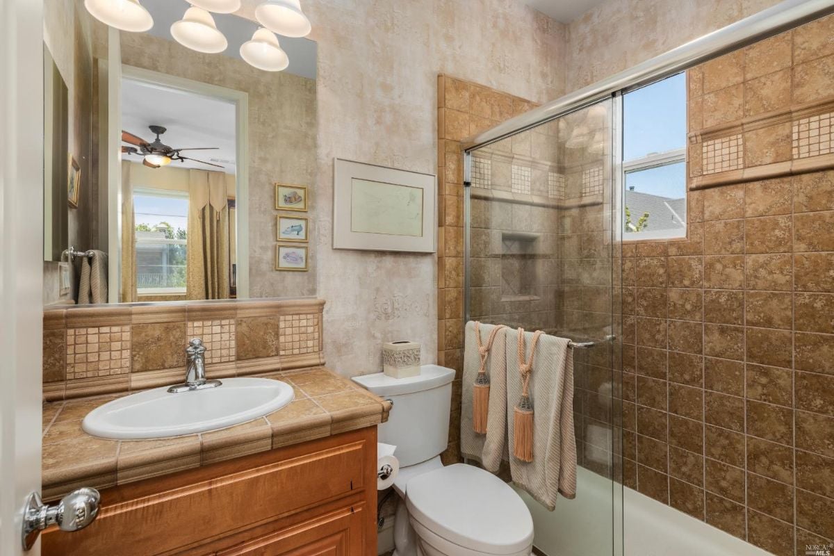 Bathroom with a sink, a shower, and a toilet.