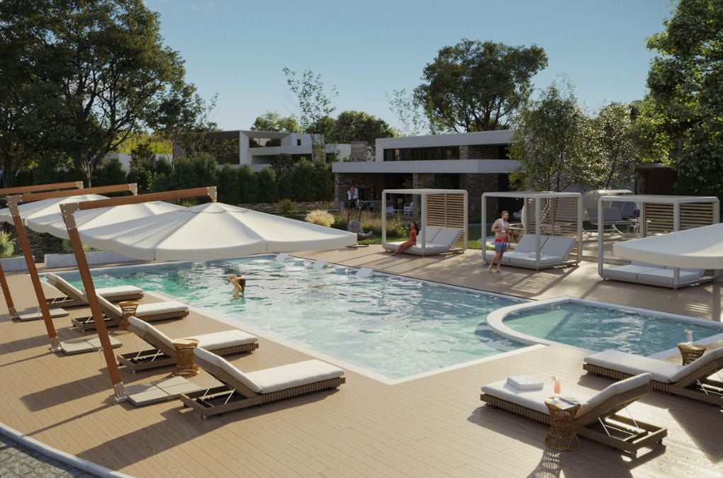 A large swimming pool with lounge chairs