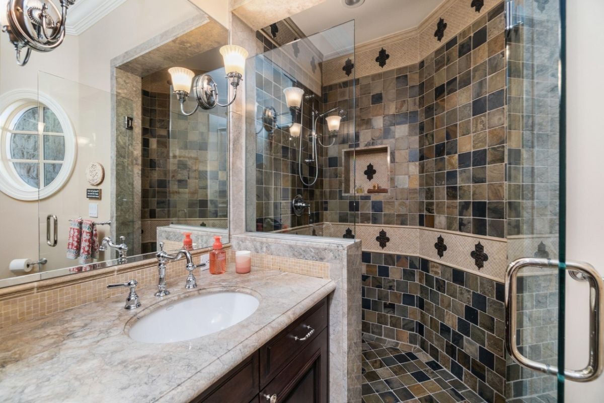 Bathroom with a sink, custom lighting and a shower.