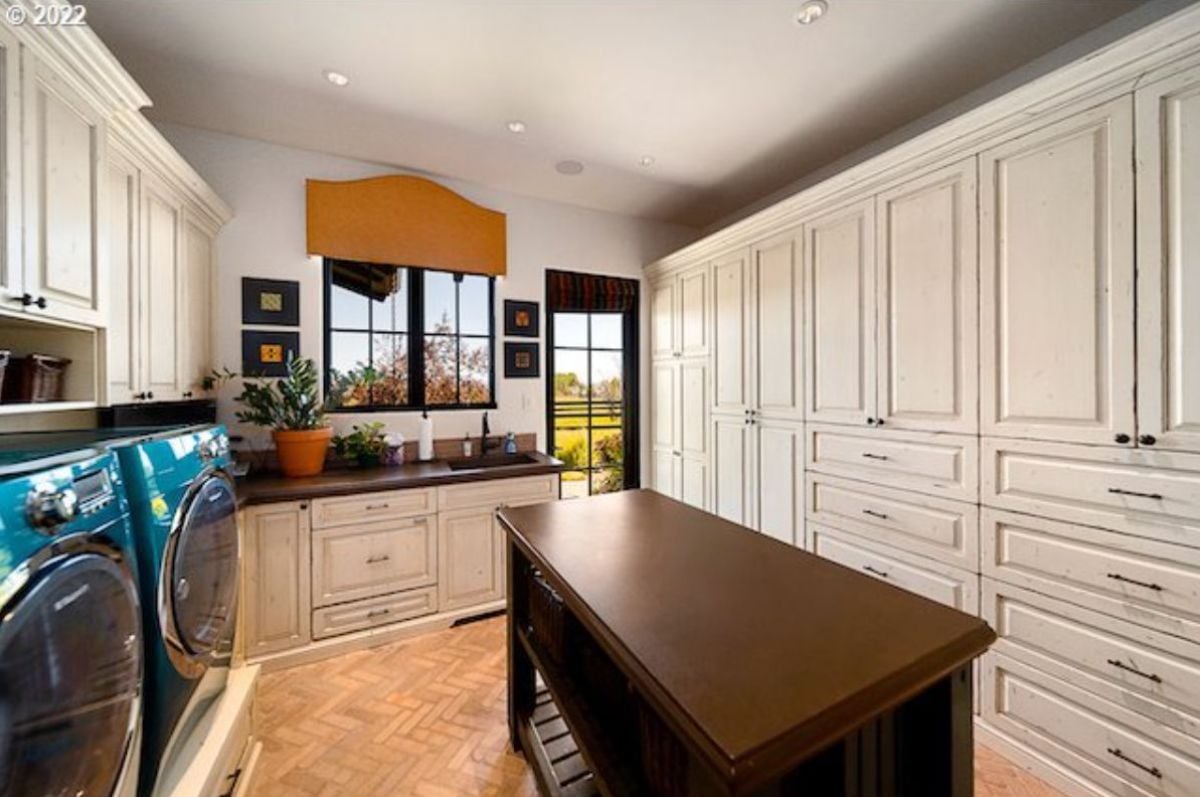 Laundry room with custom cabinetry, washer and dryer.
