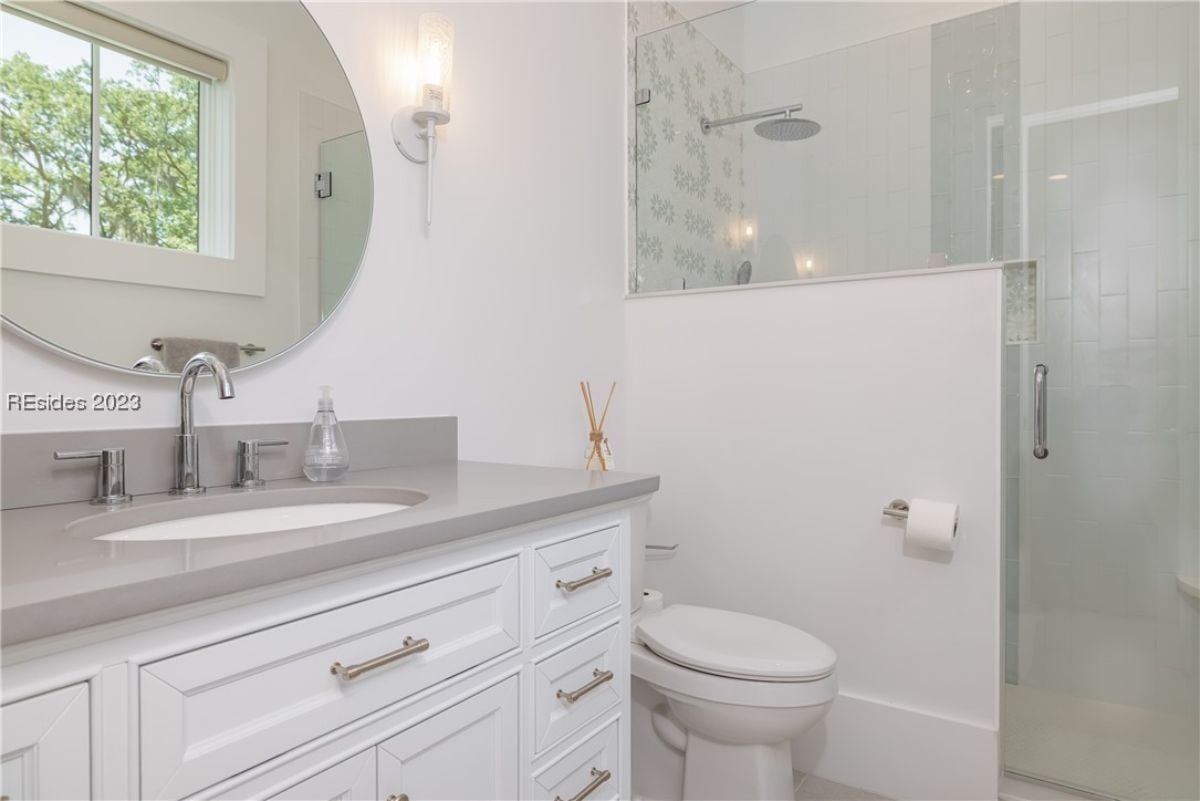 Bathroom with a sink, a shower, and a toilet.