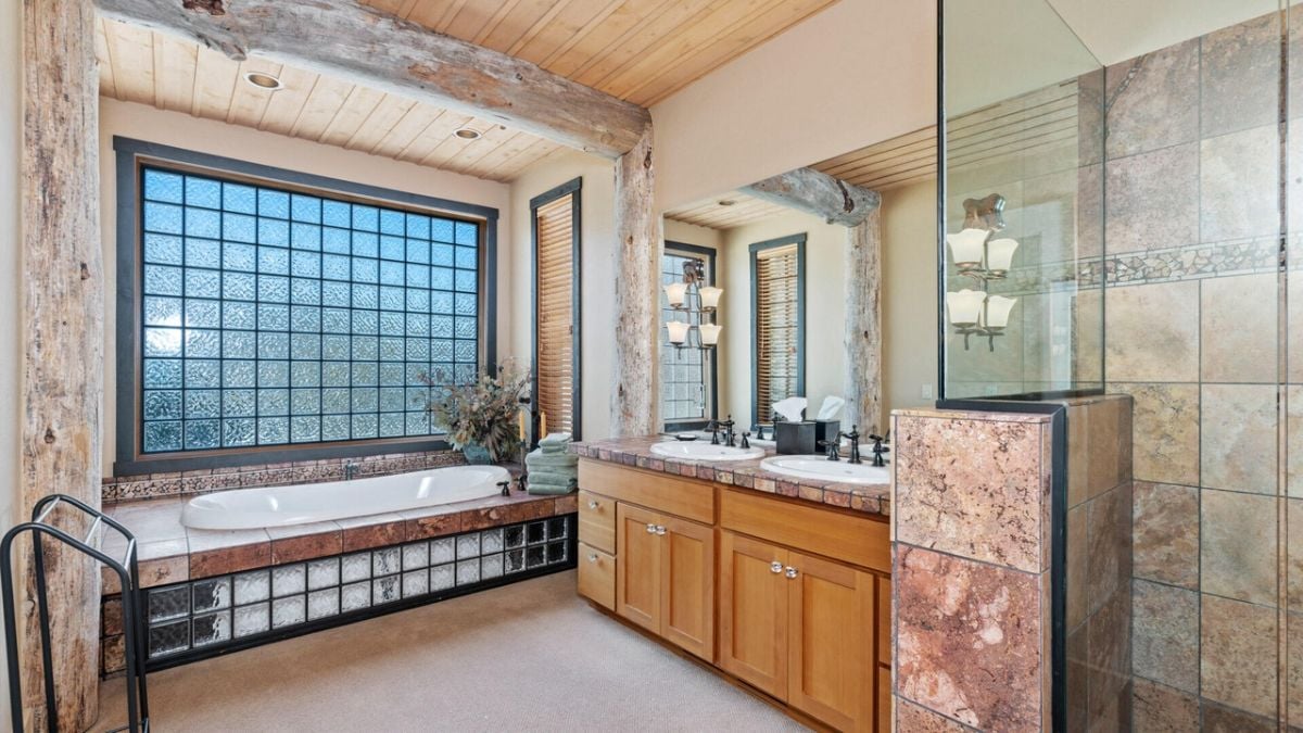 Bathroom with a bath tub sinks and shower.