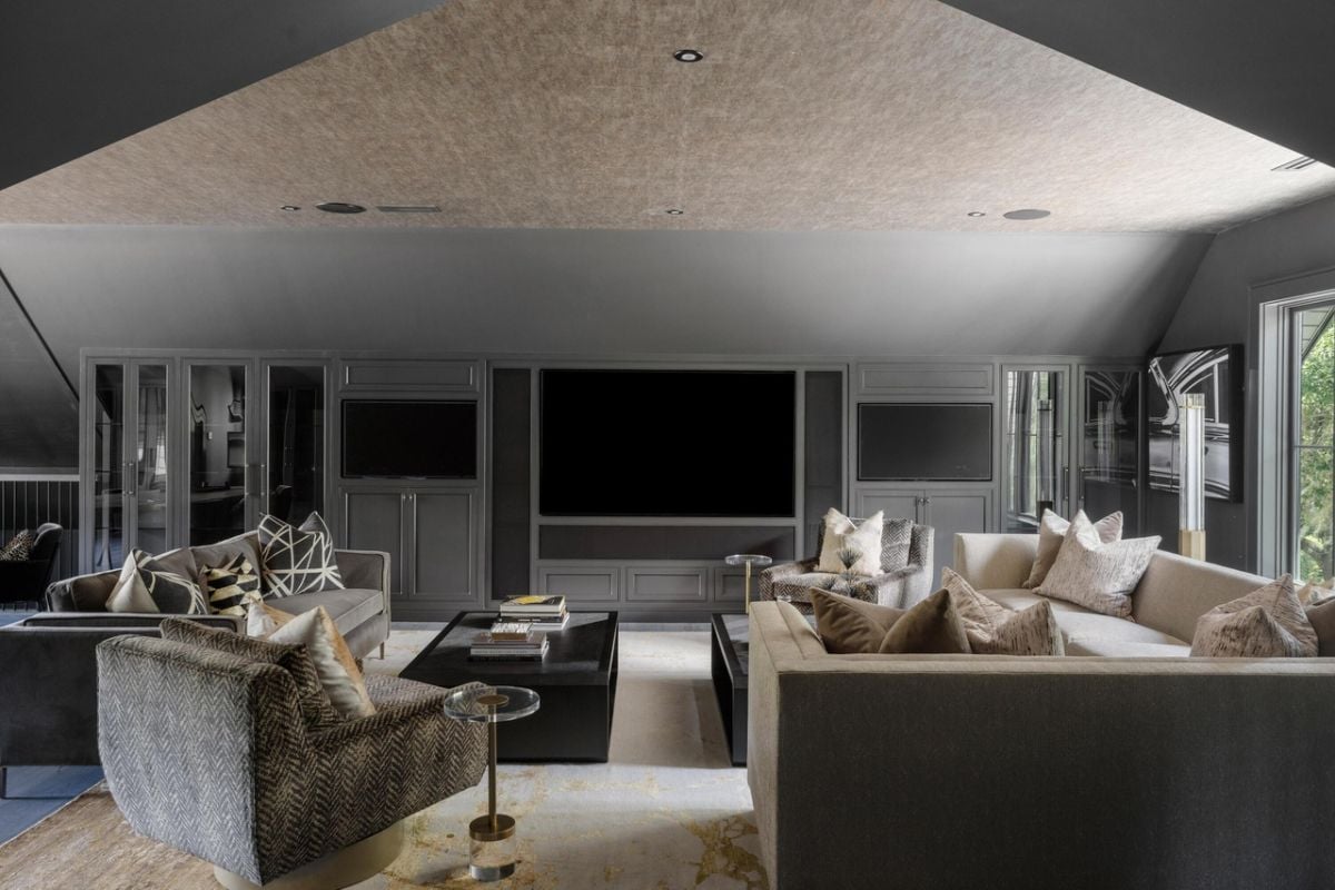 Media room with couches and a large screen.