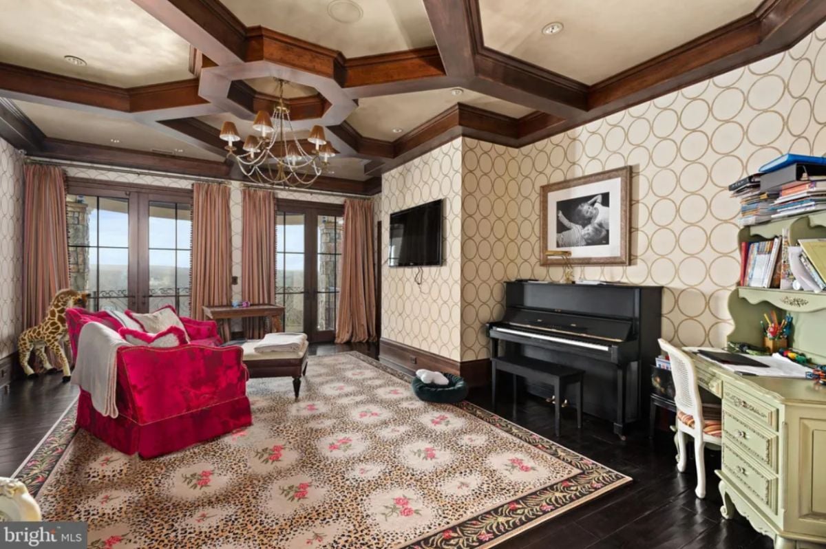 Media room with a TV and a piano.