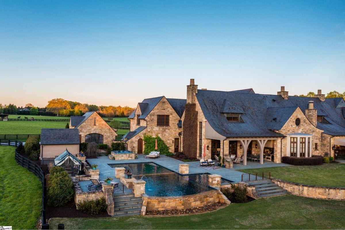 Rear view of the property with a pool.