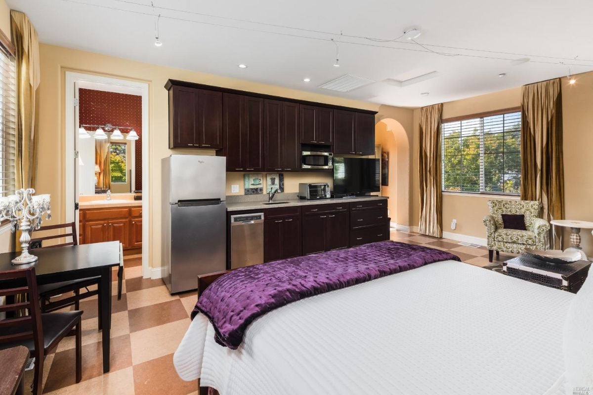 Bedroom with a TV, refrigerator and microwave.