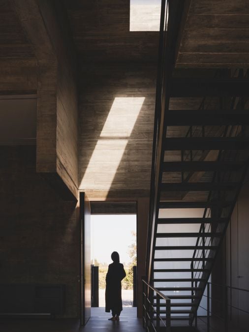 A straight staircase with metal railing