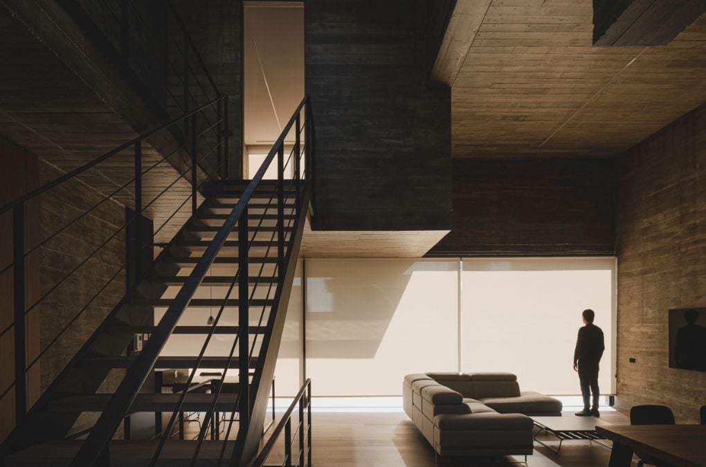 A straight staircase wit metal railing
