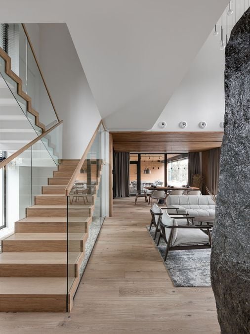 A staircase with wooden steps and glass railings