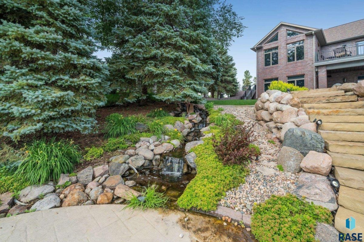Backyard waterfall with a rock garden.